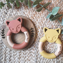 Load image into Gallery viewer, Silicone and beechwood fox face teething ring in mustard and cinnamon on a natural background.