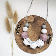 Load image into Gallery viewer, A silicone teething and breastfeeding fiddle necklace in contrasting marble, mauve and grey beads on a soft grey cord with varying textures.

