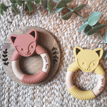 Load image into Gallery viewer, Silicone and beechwood fox face teething ring in mustard and cinnamon on a natural background. 

